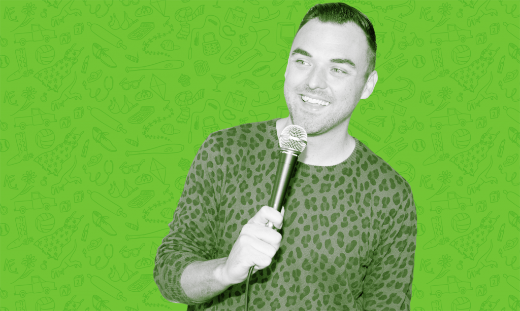 Sam Killermann Holding Microphone with Green Background